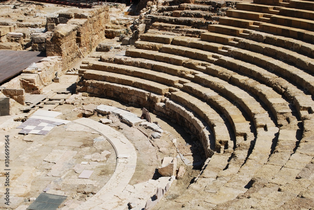 View of the Roman Amphitheatre seating area and stage in the city centre, Malaga, Spain.