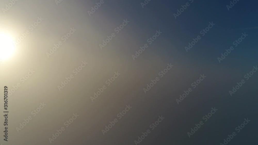Airplane cockpit aerial view moving through and upwards just above clouds showing white and grey deck and in background bright blue sky and sunshine high altitude low speed 4k resolution quality Airplane cockpit aerial view moving through and upwards just above clouds showing white and grey deck and in background bright blue sky and sunshine high altitude low speed 4k resolution quality