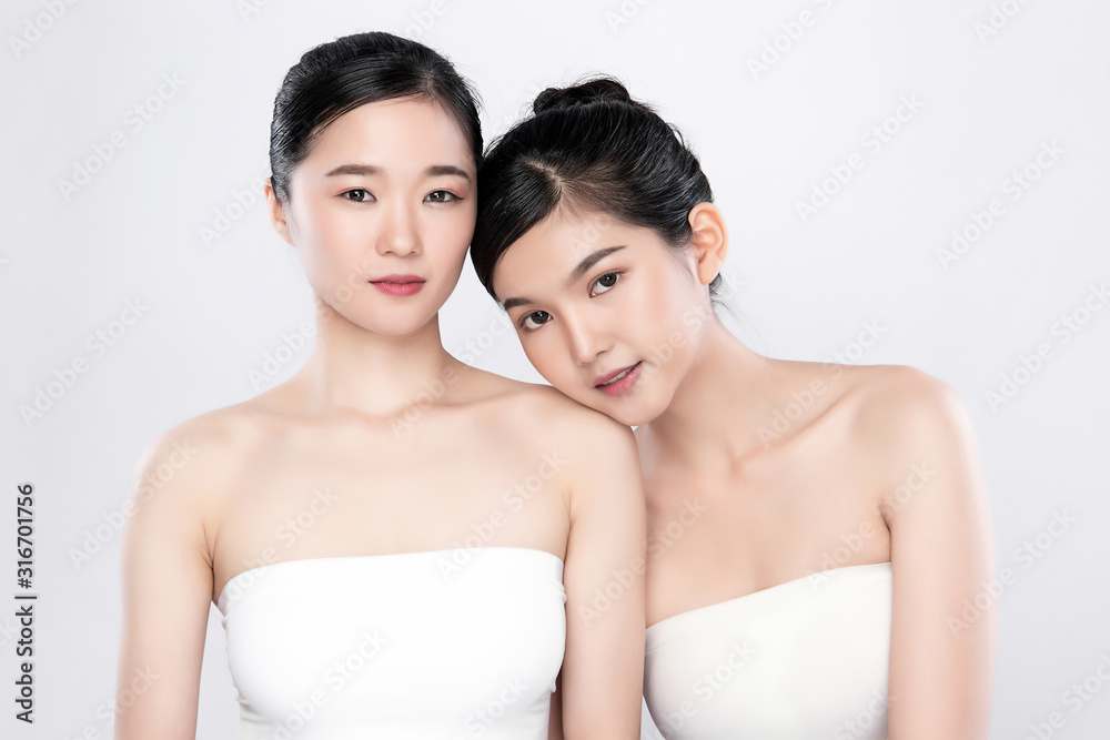 Portrait Two beautiful young asian woman clean fresh bare skin concept. Asian girl beauty face skin care and health wellness, Facial treatment, Perfect skin, Natural make up, on white background Portrait Two beautiful young asian woman clean fresh bare skin concept. Asian girl beauty face skin care and health wellness, Facial treatment, Perfect skin, Natural make up, on white background