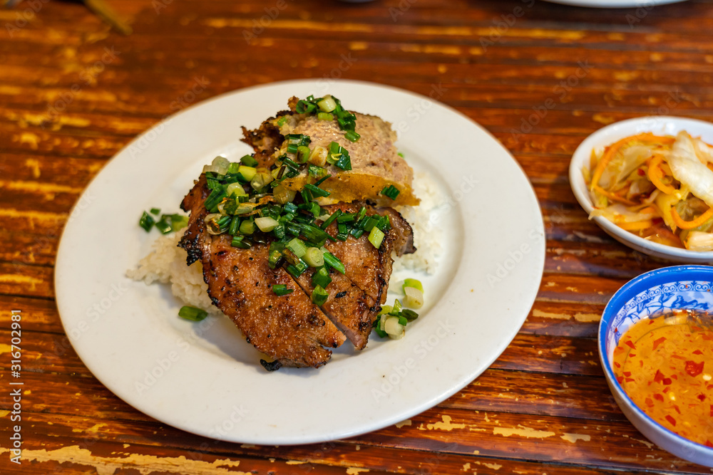Vietnamese pork chop rice served with pickles and fish sauce Vietnamese pork chop rice served with pickles and fish sauce