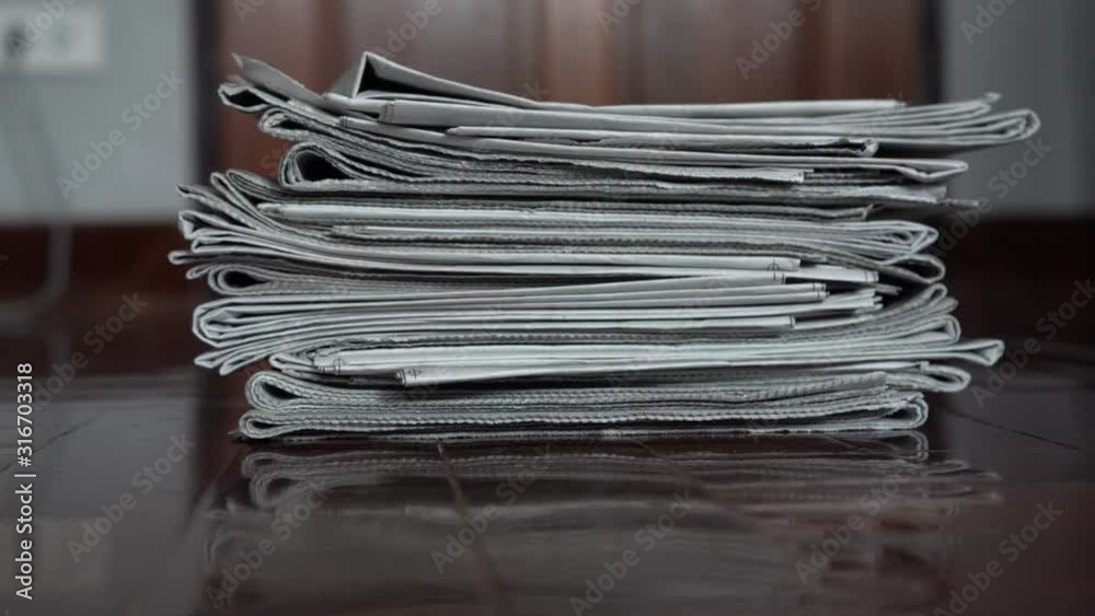 Dropping a pile of Newspaper on the floor