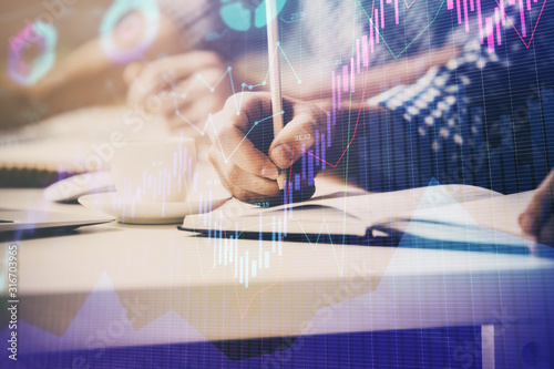 Multi exposure of two men planing investment with stock market forex chart.