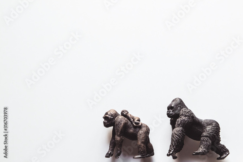 Two Toy Silver back gorilla back to back with white background