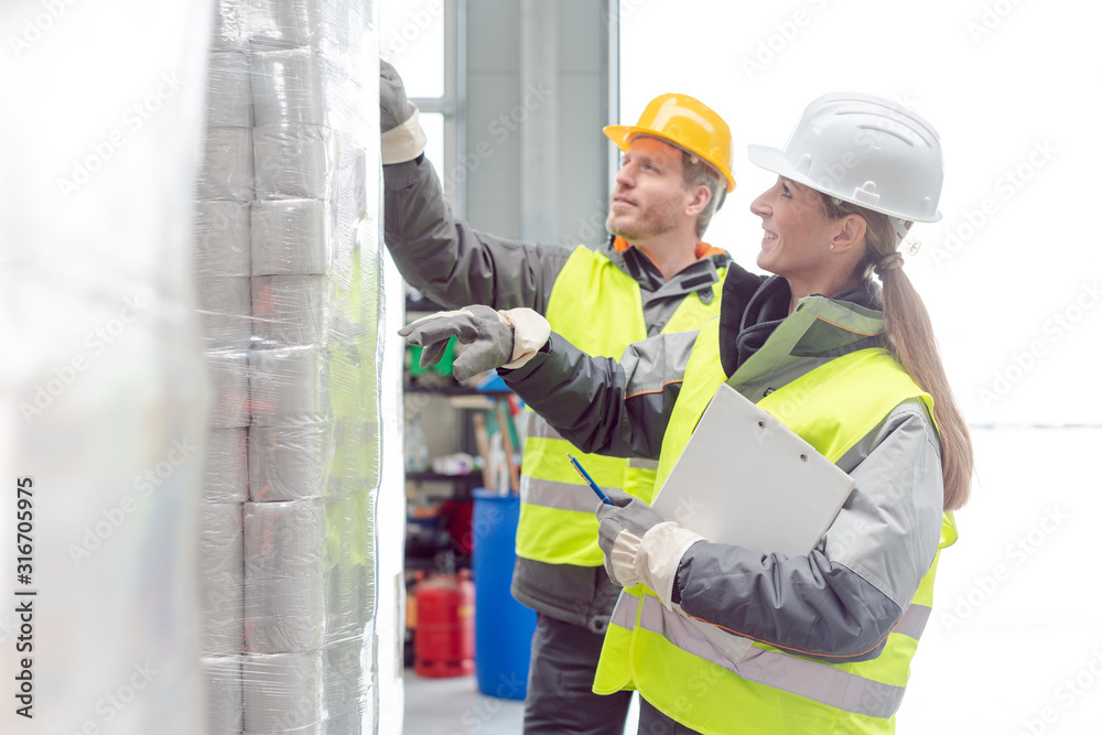 Workers in the rental toilet business checking the paper stock