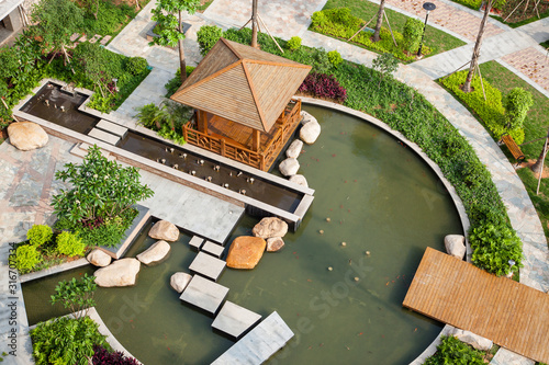 Canvas Print Beautiful garden with summerhouse and pool in a Chinese new residential district