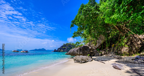 Tropical Papaya beach at paradise coast  El Nido  Palawan  Philippines. Tour A Route. Coral reef and sharp limestone cliffs.