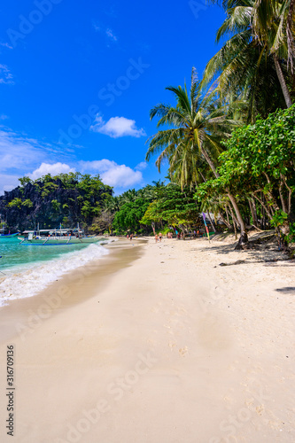 Tropical Papaya beach at paradise coast  El Nido  Palawan  Philippines. Tour A Route. Coral reef and sharp limestone cliffs.
