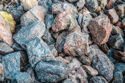 Large sharp gray wet stones background. Pink-blue hue texture