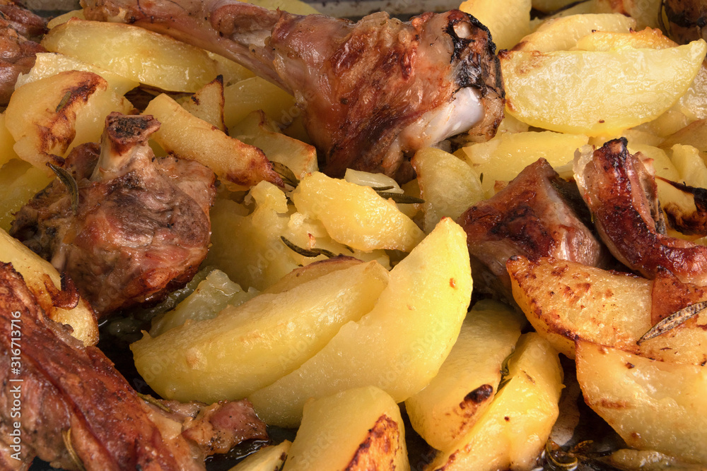 Baked potato and lamb meat with rosemary cooked in the oven, bac Baked potato and lamb meat with rosemary cooked in the oven, bac