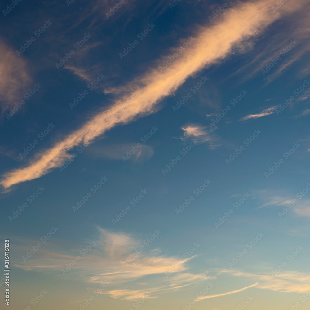 blue sky with white clouds beautifully lit by the sun as a background blue sky with white clouds beautifully lit by the sun as a background