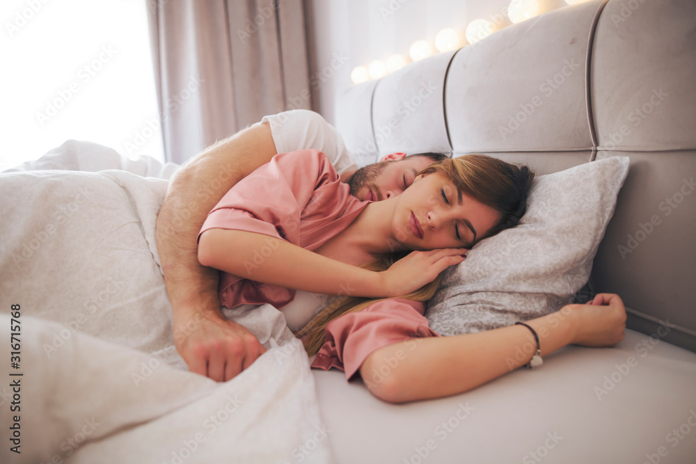 Couple lying in bed and sleeping. Stock Photo