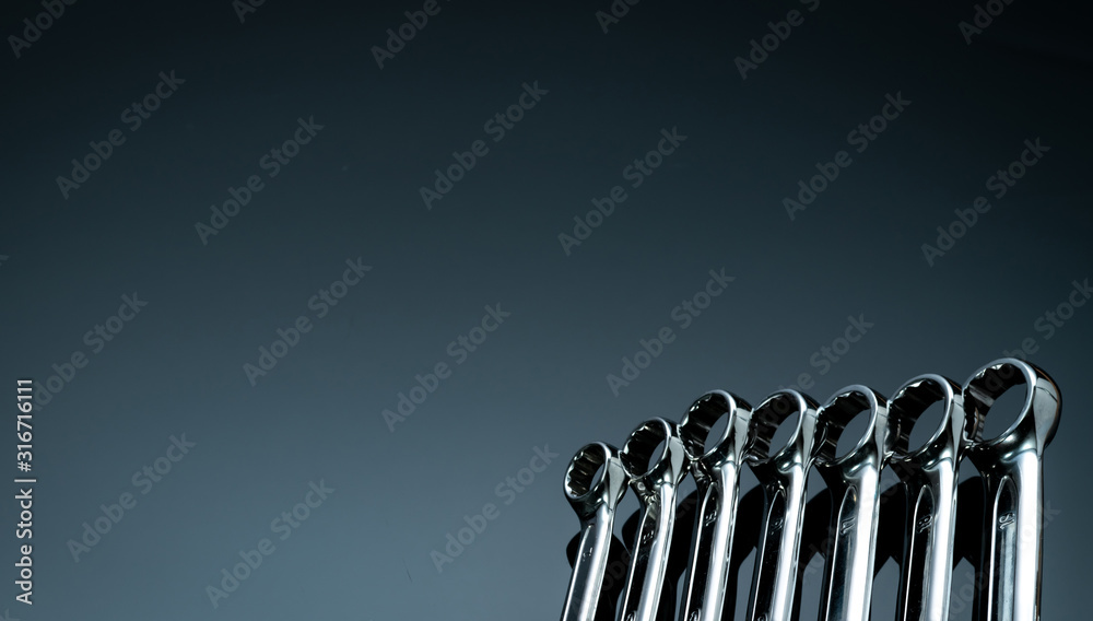 Set of chrome wrenches or spanners isolated on glass table in workshop. Chrome vanadium spanner wrench. Silver wrenches. Mechanic tools. Hardware for service technician to fix and maintenance. Set of chrome wrenches or spanners isolated on glass table in workshop. Chrome vanadium spanner wrench. Silver wrenches. Mechanic tools. Hardware for service technician to fix and maintenance.