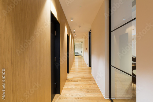 Slika na platnu Interior of a long hotel corridor, doorway
