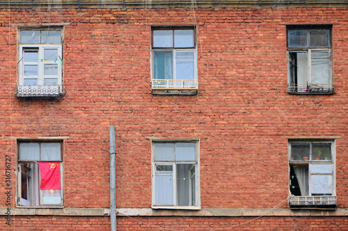 Red flag of the Soviet Union on an old brick building