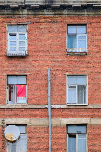 Red USSR flag hung on an old window in Russia, Moscow
