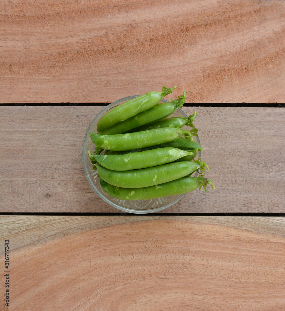 Fresh green peas on wooden background Fresh green peas on wooden background