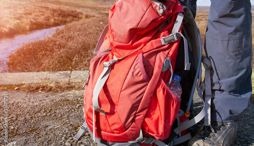 A closeup of a red hiking backpack used to carry extra clothing and safety gear when out in the countryside.
