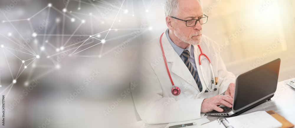 Senior doctor using laptop; light effect Senior doctor using laptop; light effect