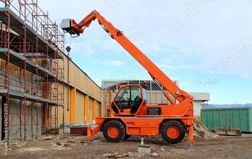 Rotating telehandler at work in a redevelopment area.
