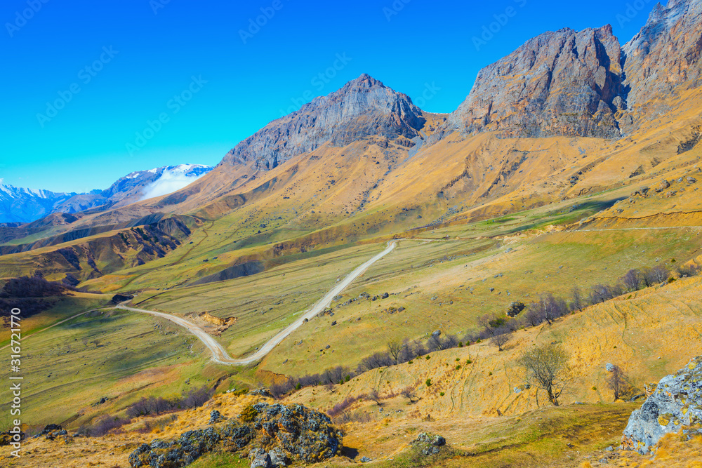 beautiful rural scene of deserted Caucasus mountains with road, Russia, Republic Ingushetia