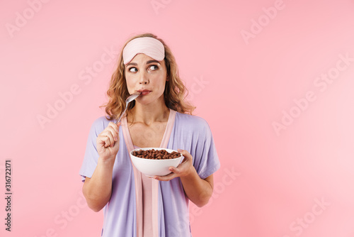 Image of caucasian thinking woman eating instant breakfast