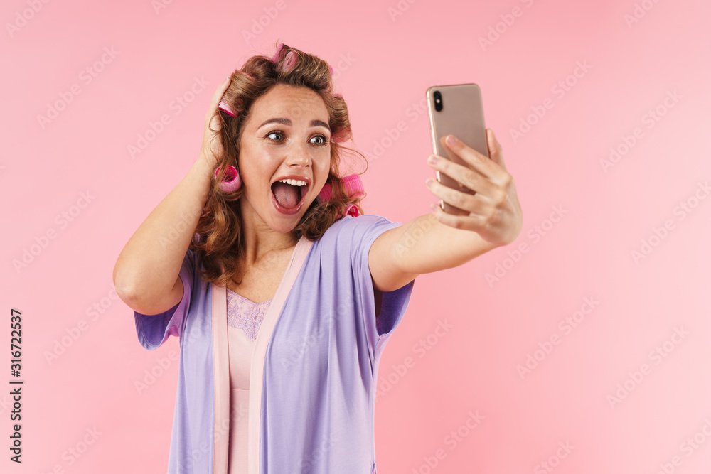 Image of young excited woman taking selfie on cellphone Image of young excited woman taking selfie on cellphone