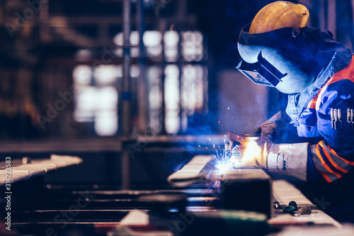 Worker welding in a factory. photo