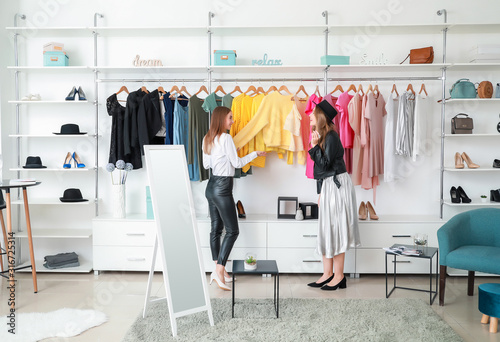 Seller helping young woman ...