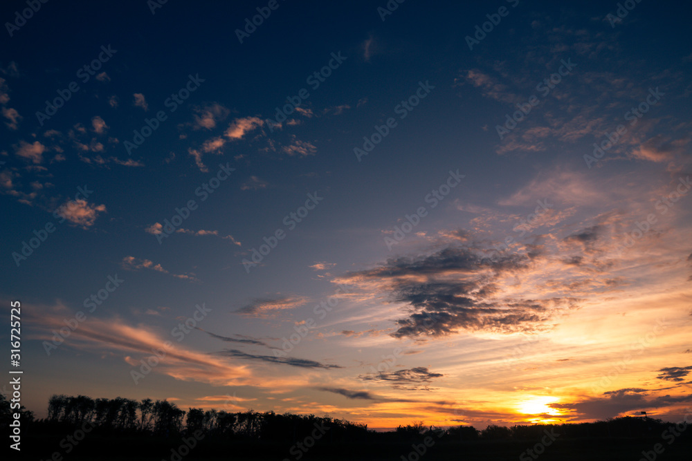 Fototapeta premium Beautiful clouds of golden and pink colors during sunset. Heaven heaven. Natural landscapes