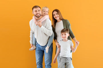 Portrait of happy family on color background