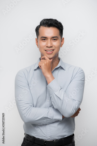 Businessman with hand on chin thinking
