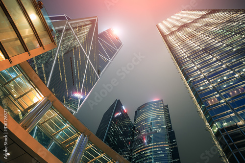 Bank of China tower building. That skyscraper in Hong kong city with modern architecture exterior design. Night sky reflection with glass of window. Center of corporate, business, financial service. photo
