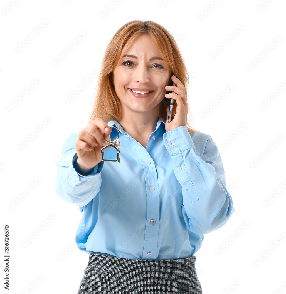 Female real estate agent talking by mobile phone on white background Female real estate agent talking by mobile phone on white background