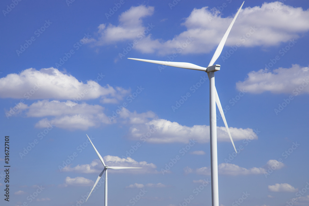 Wind turbine in blue sky with clouds background. Clean energy, renewable energy and ecology concept. Wind turbine in blue sky with clouds background. Clean energy, renewable energy and ecology concept.