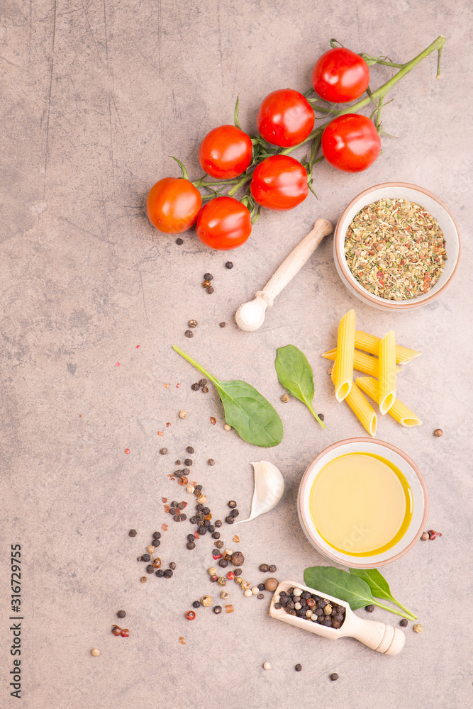 Pasta with tomatoes, spices and olive oil on a brown textured background, mediterranean food, empty copy space Pasta with tomatoes, spices and olive oil on a brown textured background, mediterranean food, empty copy space