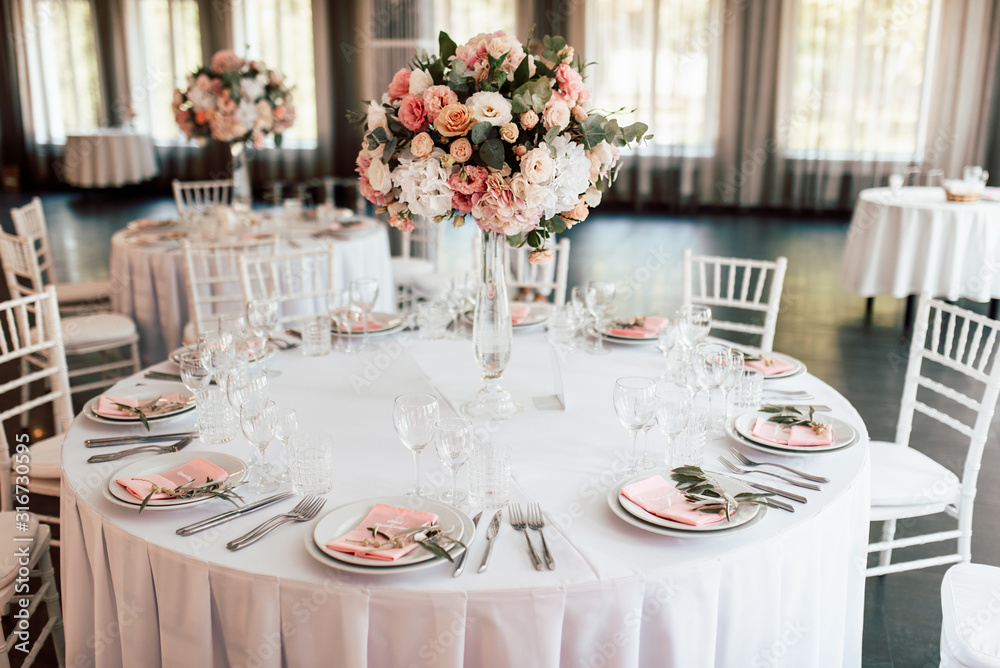 Festive table setting with a floral arrangement in the center and with a table number