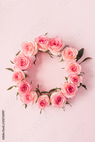 Round frame border of pink rose flower buds on pink background. Mockup blank copy space. Flat lay, top view floral composition. © Floral Deco