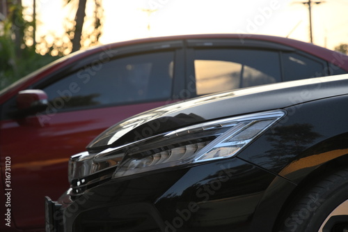 closeup headlight led of black modern car in the morning scene © sutichak