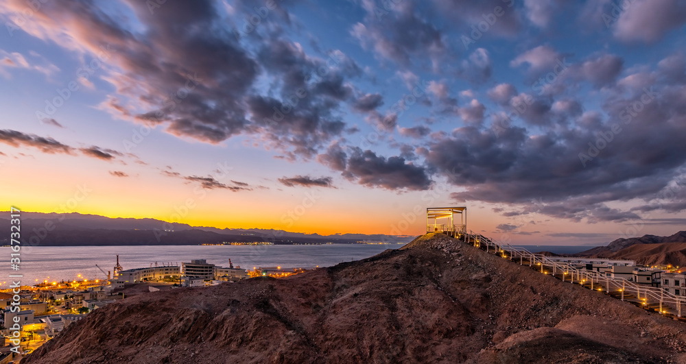 Sunrise at a top of the mount and illuminated stair-steps and pergola, photo taken in nature public park, vicinity of Eilat - famous tourist  resort and recreational city in Israel