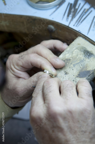 Close-up of a mature man repairing ring