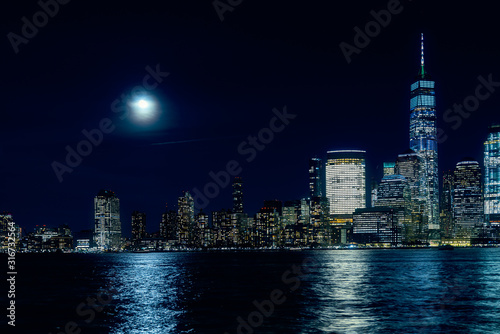 Amazing panorama view on New York City skyline and Downtown Manhattan from Jersey City during night and Full Moon © manuta
