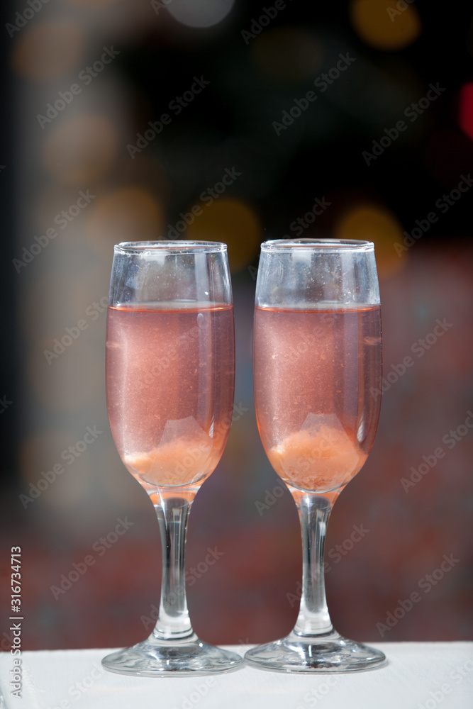 Two glasses of pink champagne for the couple. Two glasses of pink champagne for the couple.