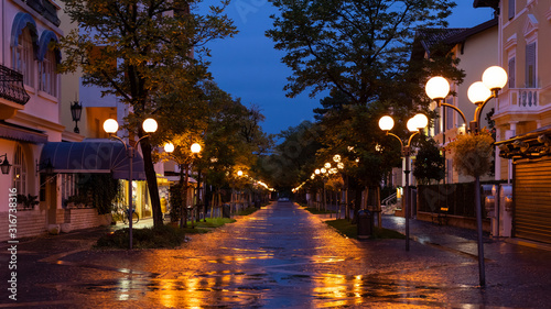 Street in Grado during rainy night in autumn