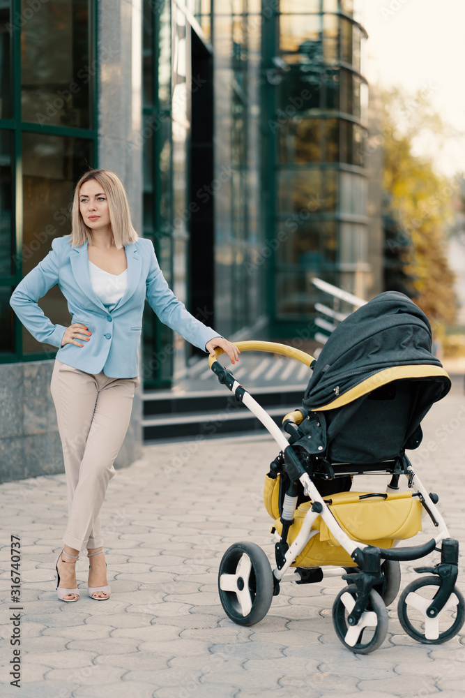 Portrait of a successful business woman in blue suit with baby Portrait of a successful business woman in blue suit with baby