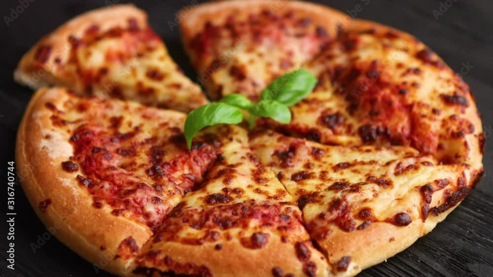 Sliced pizza Margarita with basil leafs