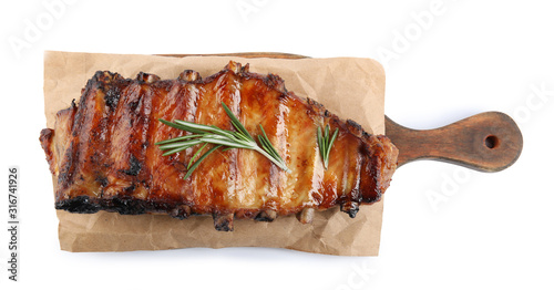 Tasty grilled ribs with rosemary isolated on white, top view photo