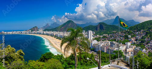 Copacabana beach in Rio de Janeiro, Brazil. Copacabana beach is the most famous beach of Rio de Janeiro, Brazil. Skyline of Rio de Janeiro with flag of Brazil photo