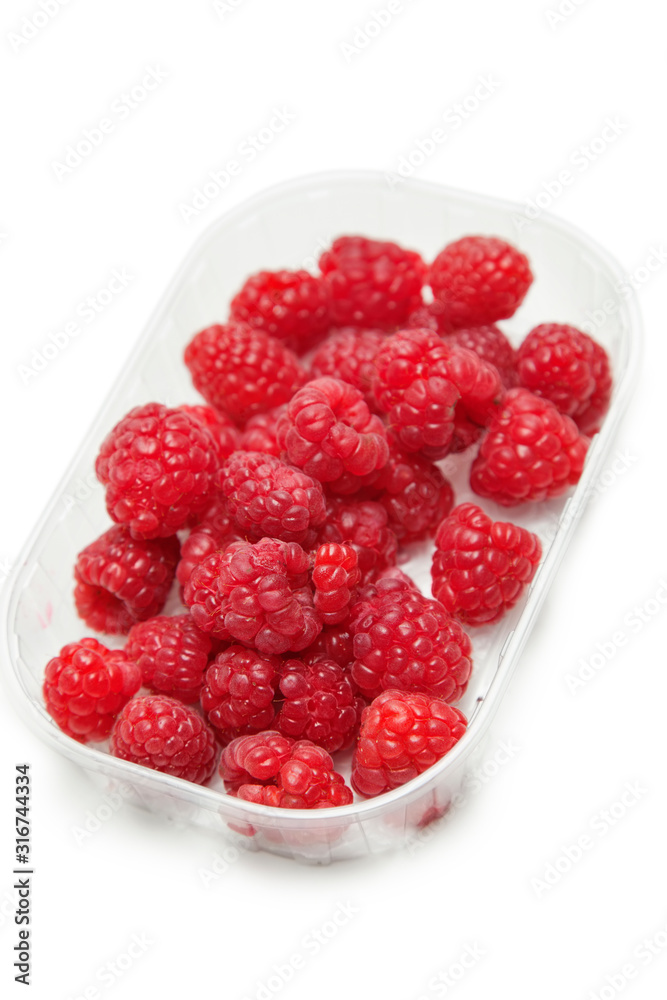 Fresh raspberries in a container against white background Fresh raspberries in a container against white background