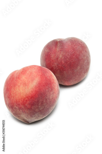 Two peaches against white background
