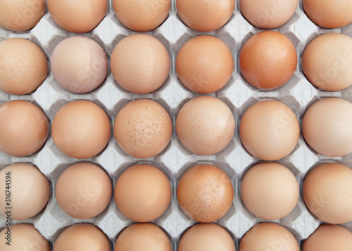 Full-Frame shot of brown eggs arranged in carton